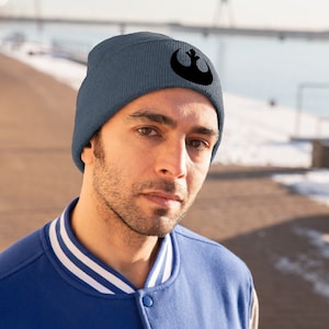 May include: A blue beanie with a black Rebel Alliance symbol on the front.
