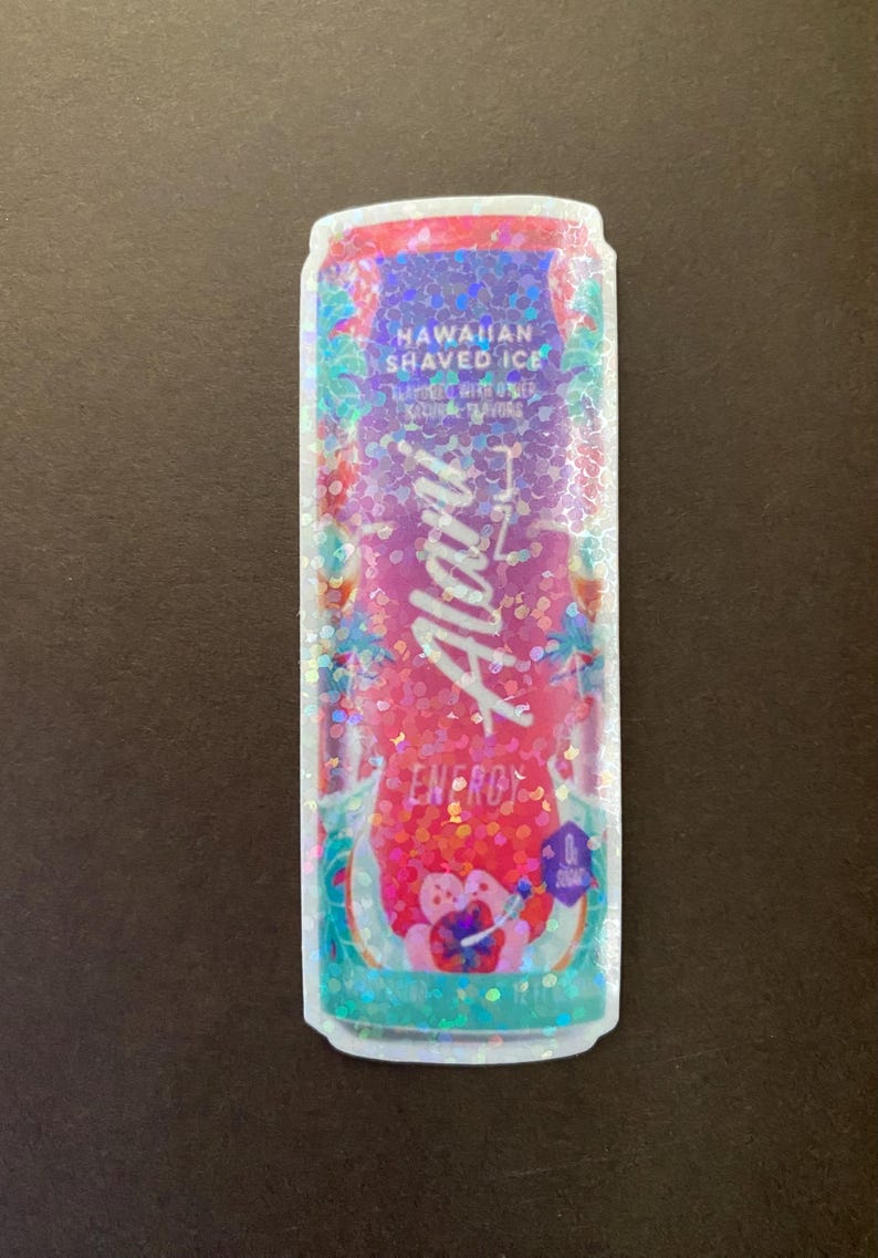 May include: A holographic sticker of a can of Aloha energy drink. The can is pink and blue with a design of palm trees and flowers. The text on the can reads "Hawaiian Shaved Ice" and "Aloha Energy".