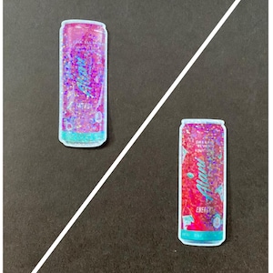 May include: Two colorful aluminum cans with a glittery finish. The can on the left is pink and says "Pink Slush" and the can on the right is red and says "Cherry Slush".