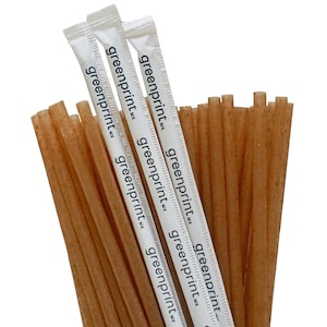 May include: A bundle of brown, biodegradable drinking straws with white paper wrappers. The wrappers have the text "greenprint" printed on them.