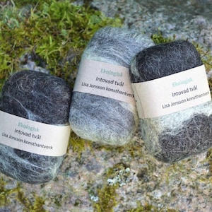 May include: Three black and gray felted soap bars with white labels that read "Ekologisk Intovad tvål Lisa Jonsson konsthantverk".
