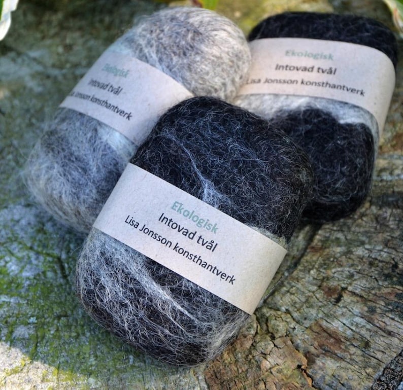 May include: Three handmade soap bars wrapped in felted wool. The soap bars are labelled "Ekologisk Intovad tv&aring;l Lisa Jonsson konsthantverk".