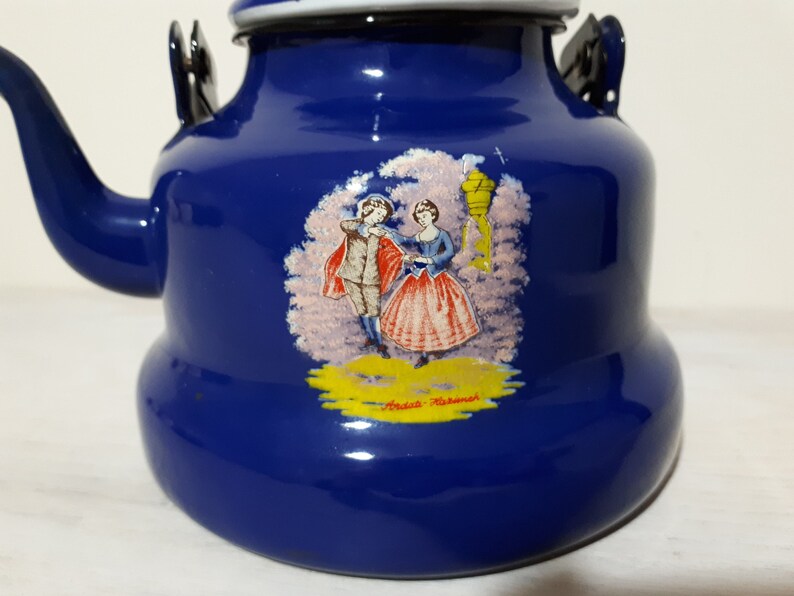 Vintage blue enamel teapot kettle with colonial couple design