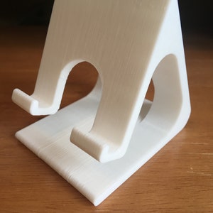 Universal Phone stand with charging wire port