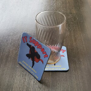 May include: Two blue and red coasters with the text "IT Support" and a superhero figure saving the world one mouse click at a time.