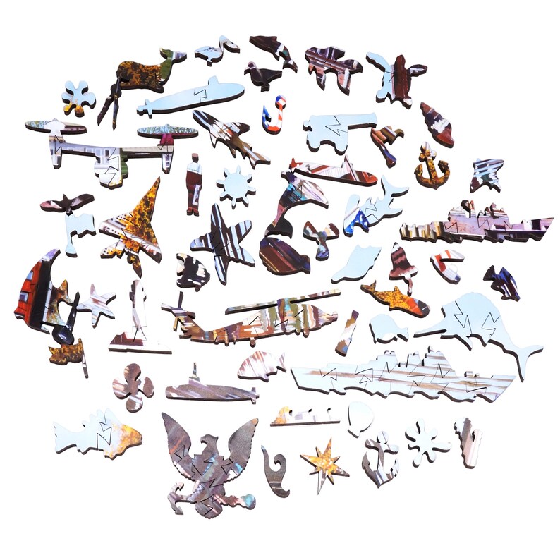 May include: A wooden jigsaw puzzle with various military and nautical themed shapes. The puzzle pieces include airplanes, ships, submarines, and an eagle. The pieces are painted with a variety of colors and patterns.