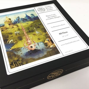 May include: A black box with a white label featuring a 400-piece jigsaw puzzle of Hieronymus Bosch's "The Garden of Earthly Delights." The label also includes the title "Beasts From The Garden of Earthly Delights" and the text "Nautilus Wooden Puzzles."