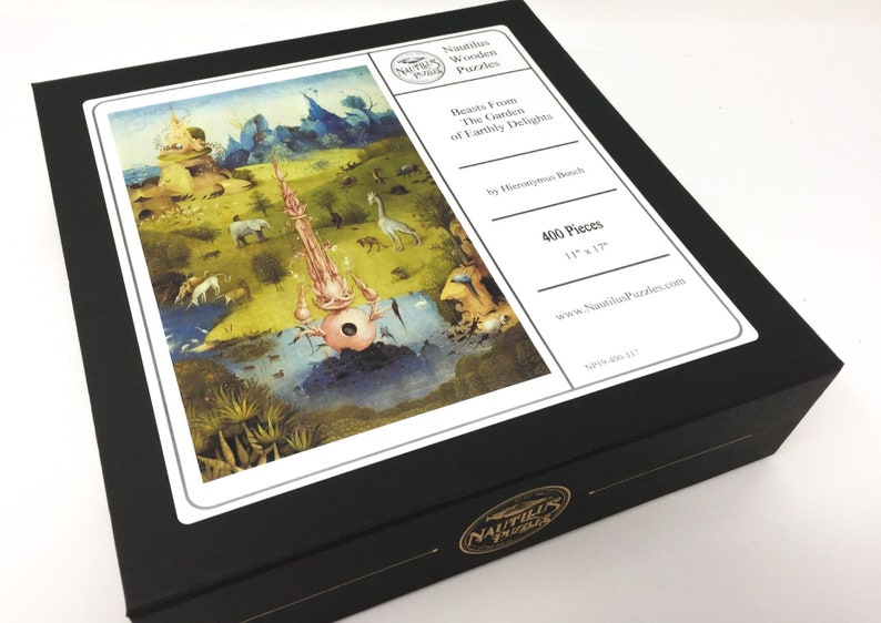 May include: A black box with a white label featuring a 400-piece jigsaw puzzle of Hieronymus Bosch's "The Garden of Earthly Delights." The label also includes the title "Beasts From The Garden of Earthly Delights" and the text "Nautilus Wooden Puzzles."