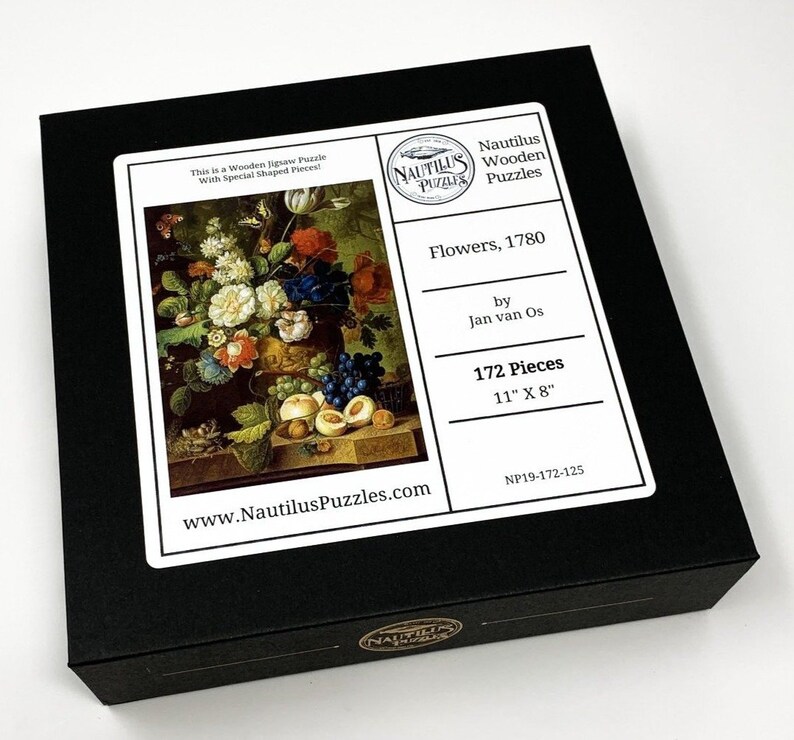 May include: A black box with a white label featuring a painting of a vase of flowers and fruit. The label also includes the text "Nautilus Wooden Puzzles", "Flowers, 1780", "by Jan van Os", "172 Pieces", "11" X 8"", and "www.NautilusPuzzles.com".