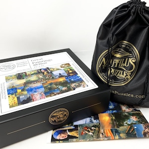 May include: A black box set of a 366-piece wooden jigsaw puzzle featuring famous paintings. The box is labeled "Great Paintings" and measures 15" x 11". A black drawstring bag with a gold logo and a partial image of the puzzle are also included.