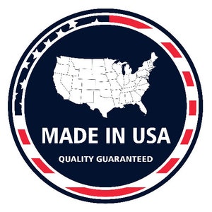 May include: A circular emblem with a navy blue background, featuring a white outline of the United States map. The text "MADE IN USA" is in white, with "QUALITY GUARANTEED" below. The border is red and white.
