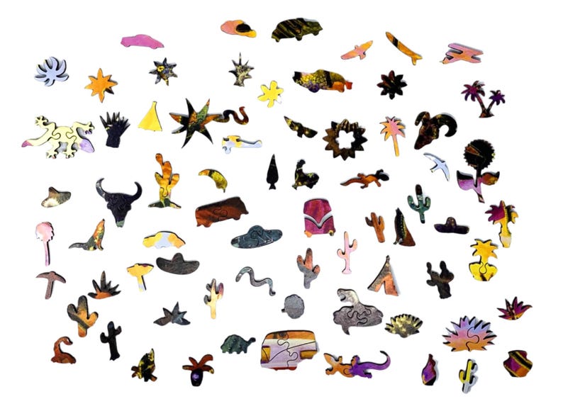 May include: A collection of wooden puzzle pieces in various shapes and colors, including cacti, stars, animals, and other desert-themed designs. The pieces are scattered against a white background, showcasing the intricate details and vibrant hues.