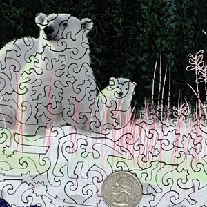 May include: A black and white jigsaw puzzle with a detailed design of two polar bears in a forest setting. The puzzle is partially assembled, with a quarter visible in the lower right corner.