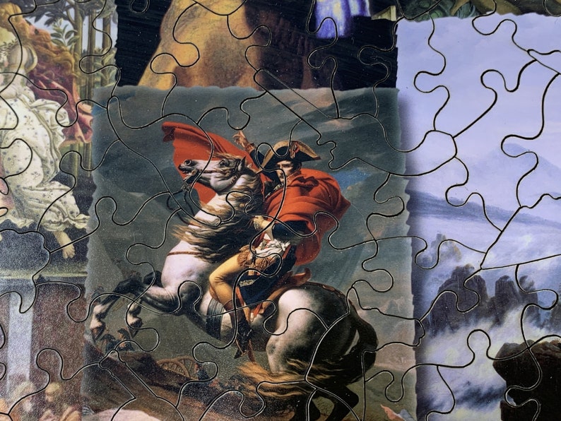 May include: A jigsaw puzzle featuring a historical painting of a man on a white horse, wearing a red coat and hat. The puzzle pieces are interlocked, with visible black lines outlining each piece. The artwork depicts a battle scene.