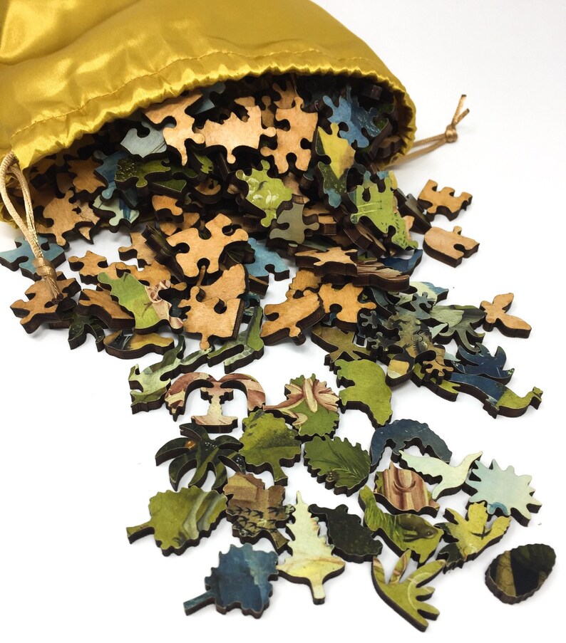 May include: A wooden jigsaw puzzle with a colorful image of a landscape scene. The puzzle pieces are scattered on a white surface and spilling out of a yellow drawstring bag.