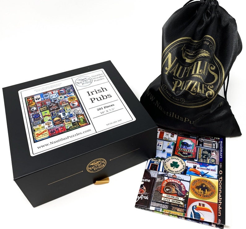 May include: A black box set featuring a 201-piece jigsaw puzzle with an Irish Pubs theme. The box has a gold-colored clasp and a white label with the puzzle's details. A black drawstring bag with a gold logo and a completed puzzle image are also visible.
