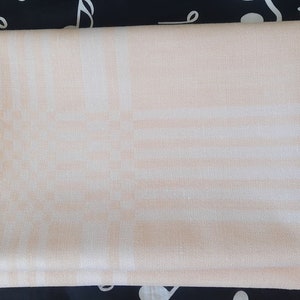 Big white and yellow/orange woven linen tablecloth. Swedish vintage 1970s.