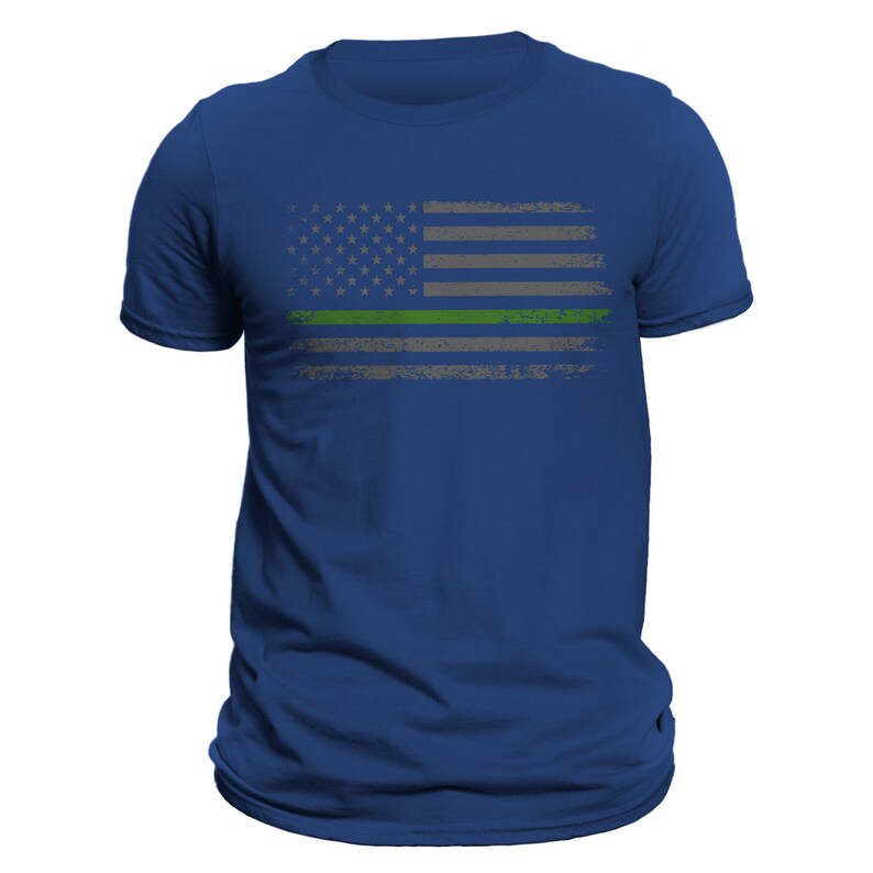 May include: A royal blue t-shirt with a distressed American flag design. The flag has a green stripe across the middle.