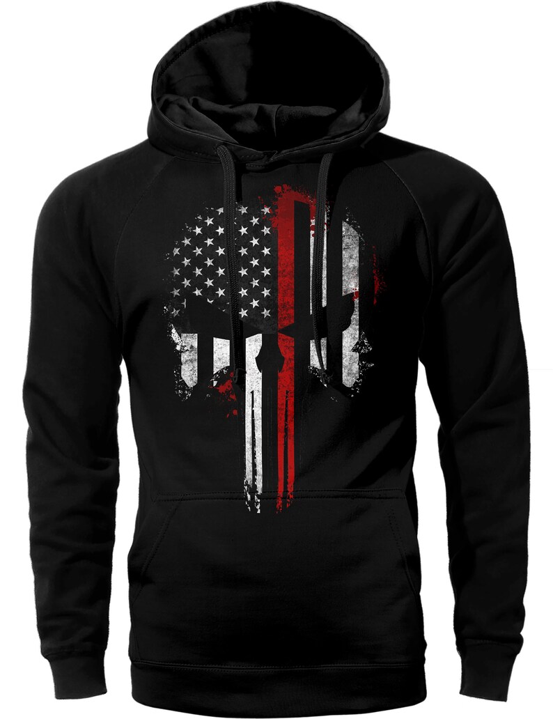 May include: Black hooded sweatshirt with a distressed American flag design featuring a skull with a red stripe down the center.