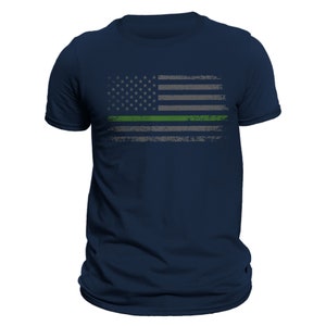 May include: A navy blue t-shirt with a distressed American flag design featuring a green stripe across the middle.