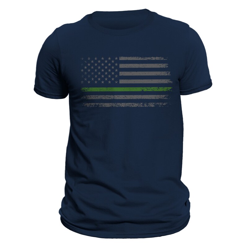 May include: A navy blue t-shirt with a distressed American flag design featuring a green stripe across the middle.