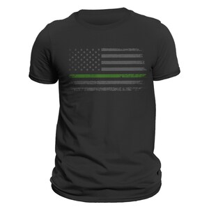May include: A black t-shirt with a distressed American flag design featuring a thin green line across the middle.