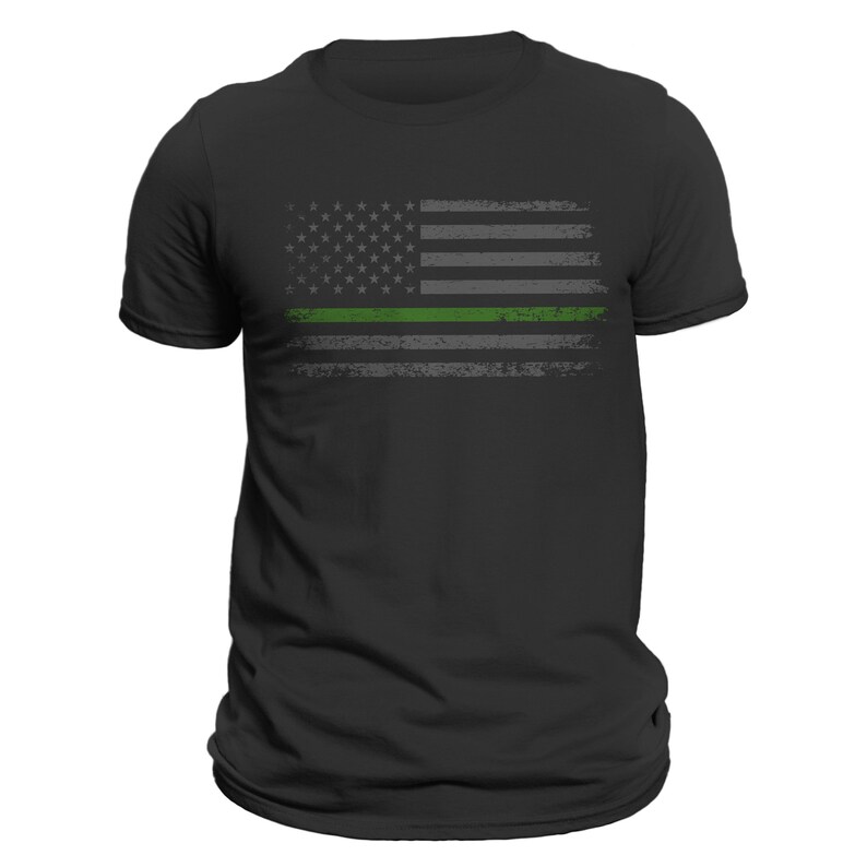 May include: A black t-shirt with a distressed American flag design featuring a thin green line across the middle.
