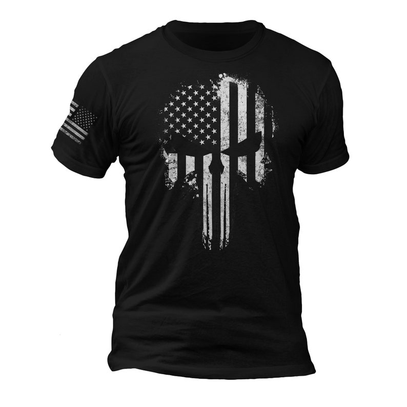 May include: Black t-shirt with a white distressed American flag skull graphic.