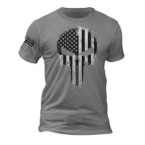 May include: A gray t-shirt with a distressed American flag design in the shape of a skull.