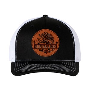 May include: Black and white trucker hat with a brown leather patch featuring the Mexican coat of arms and the text "Quintana Roo".