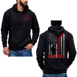 May include: Black hooded sweatshirt with a firefighter silhouette and an American flag with a red stripe on the back. The text "NAME" is printed below the image.