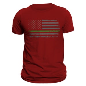 May include: Red t-shirt with a distressed American flag design featuring a thin green line across the middle.