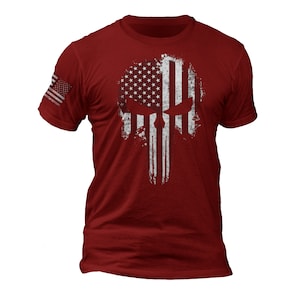 May include: Red t-shirt with a distressed American flag design in the shape of a skull.