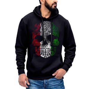 May include: Black hooded sweatshirt with a white skull graphic featuring a Mexican flag design. The skull is surrounded by green and red colors.