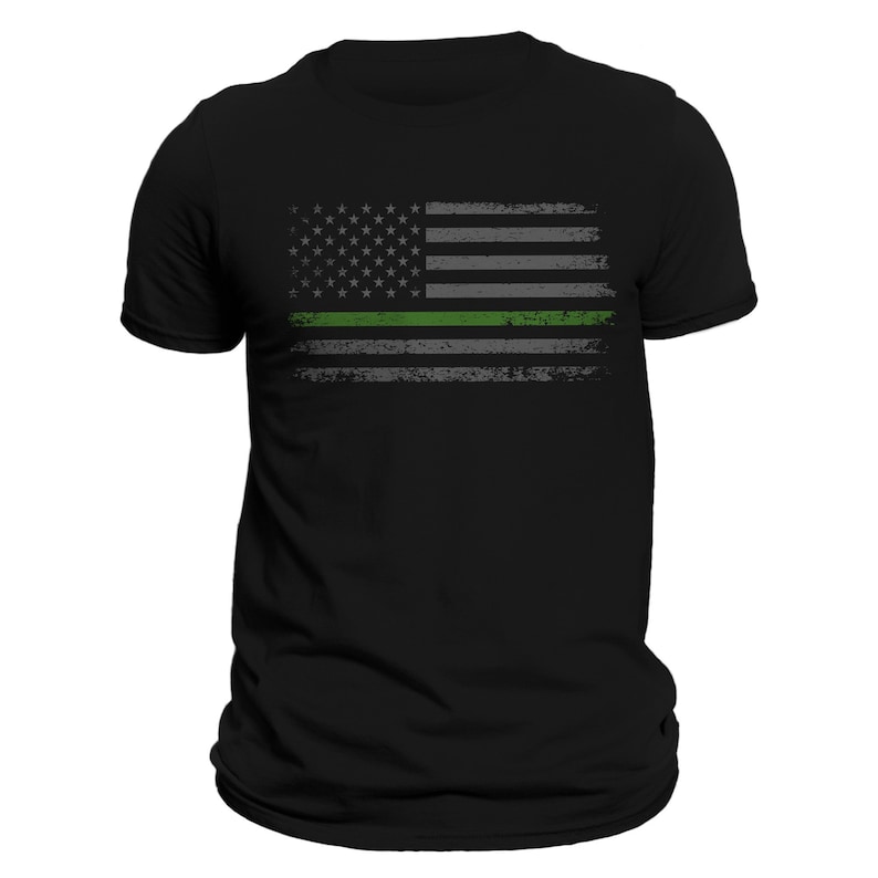 May include: Black t-shirt with a distressed American flag design featuring a thin green line across the middle.