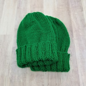 Samples of Cascade Adult Hat Knitting Pattern knit with green yarn.