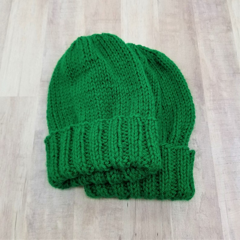 Samples of Cascade Adult Hat Knitting Pattern knit with green yarn.