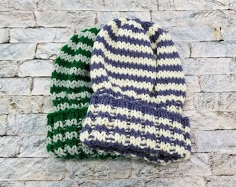 May include: Two striped knit hats, one green and white, the other purple and white.