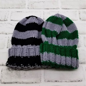 May include: Two striped knit hats, one black and grey, the other green and grey.