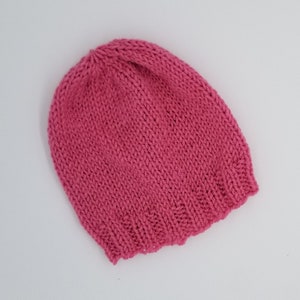 May include: A pink knitted beanie hat.