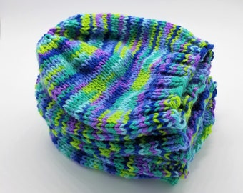 May include: A stack of colorful knitted hats in shades of blue, green, and purple. The hats are made with a striped pattern and have a soft, textured feel.