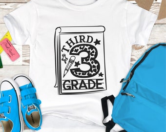 May include: White t-shirt with a black and white graphic of a notebook with the text "THIRD GRADE" and a leopard print number 3.
