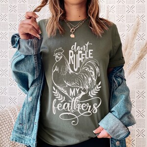 May include: A green t-shirt with a white rooster graphic and the text "Don't Ruffle My Feathers".