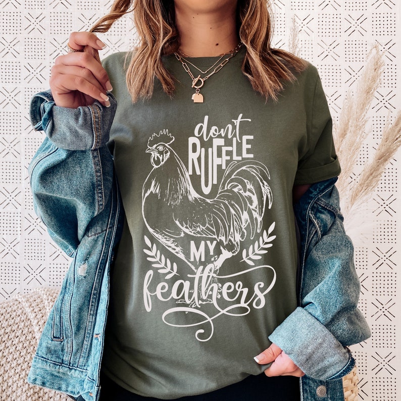 May include: A green t-shirt with a white rooster graphic and the text "Don't Ruffle My Feathers".