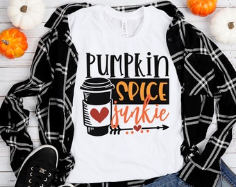 May include: White t-shirt with the text "Pumpkin Spice Junkie" in black and orange lettering. A black and white illustration of a coffee cup with a red heart is next to the text.