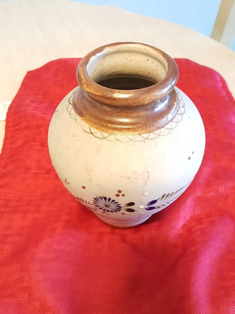 It/'s very unique and pretty. It has butterflies and flowers Hand painted ceramic vase from Mexico leaves
