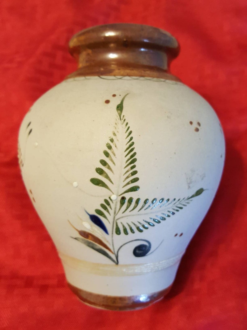 It/'s very unique and pretty. It has butterflies and flowers Hand painted ceramic vase from Mexico leaves