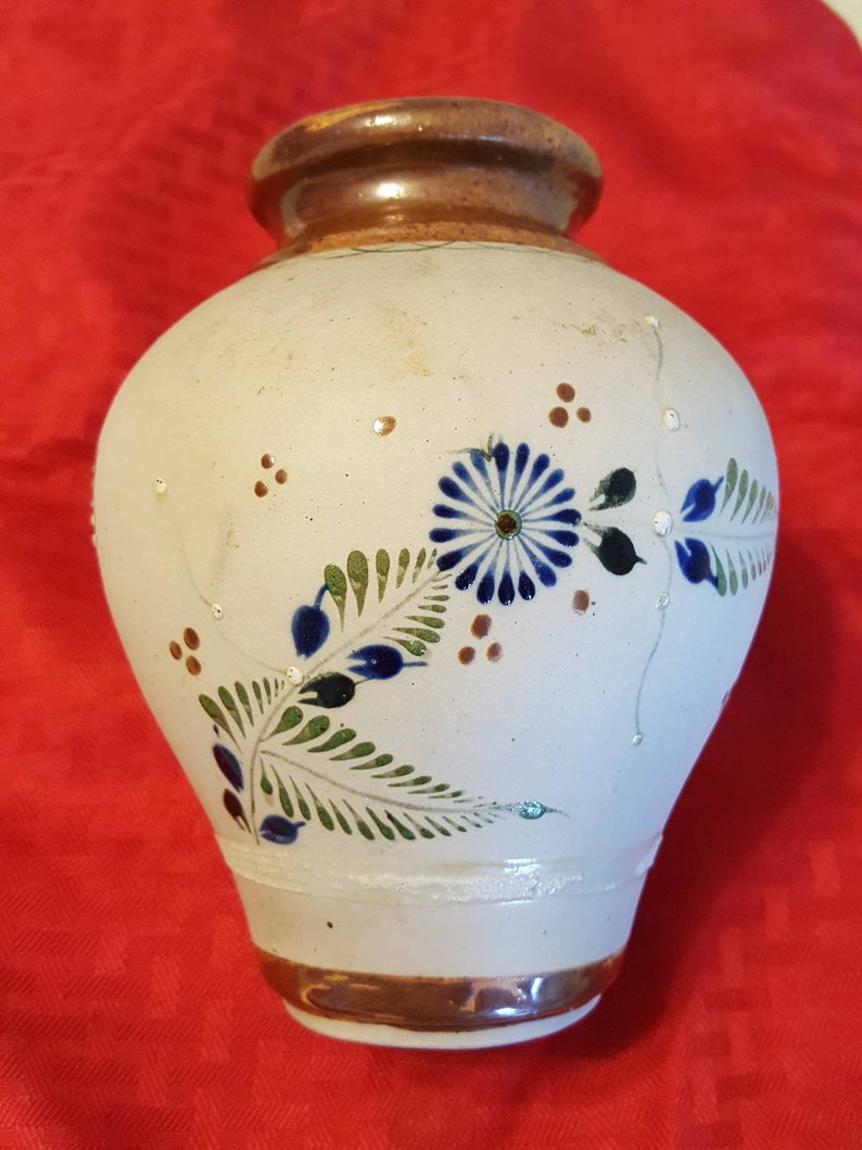 It/'s very unique and pretty. It has butterflies and flowers Hand painted ceramic vase from Mexico leaves