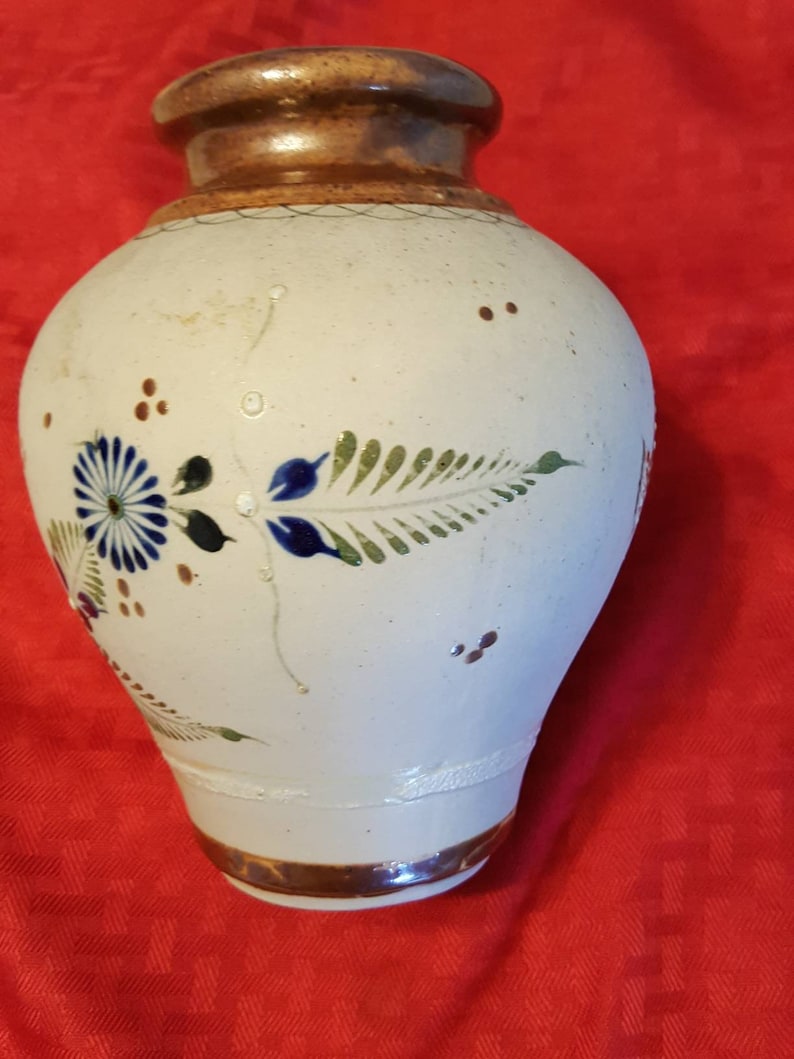 It/'s very unique and pretty. It has butterflies and flowers Hand painted ceramic vase from Mexico leaves