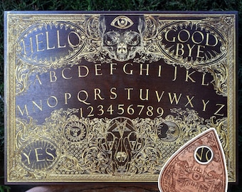May include: A wooden Ouija board with gold accents and an ornate design. The board features the alphabet, numbers, "yes", "no", "hello", and "goodbye". A separate planchette is also included.